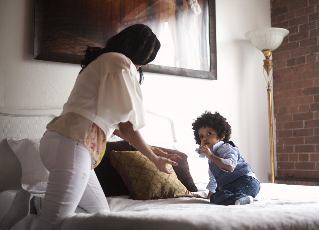 mom and toddler on bed