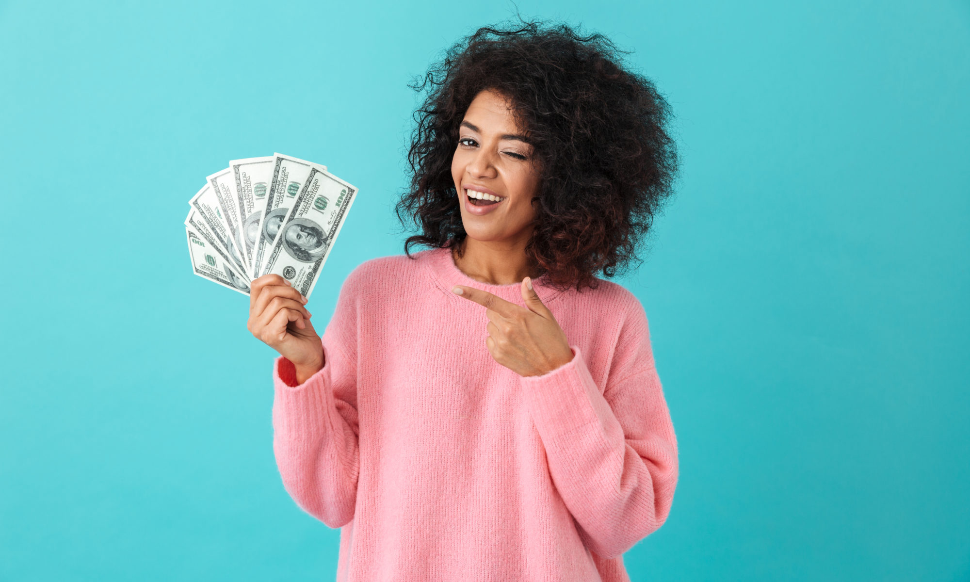 happy woman holding cash and smiling