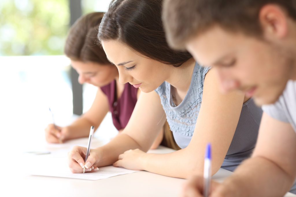 close up of three students taking a test