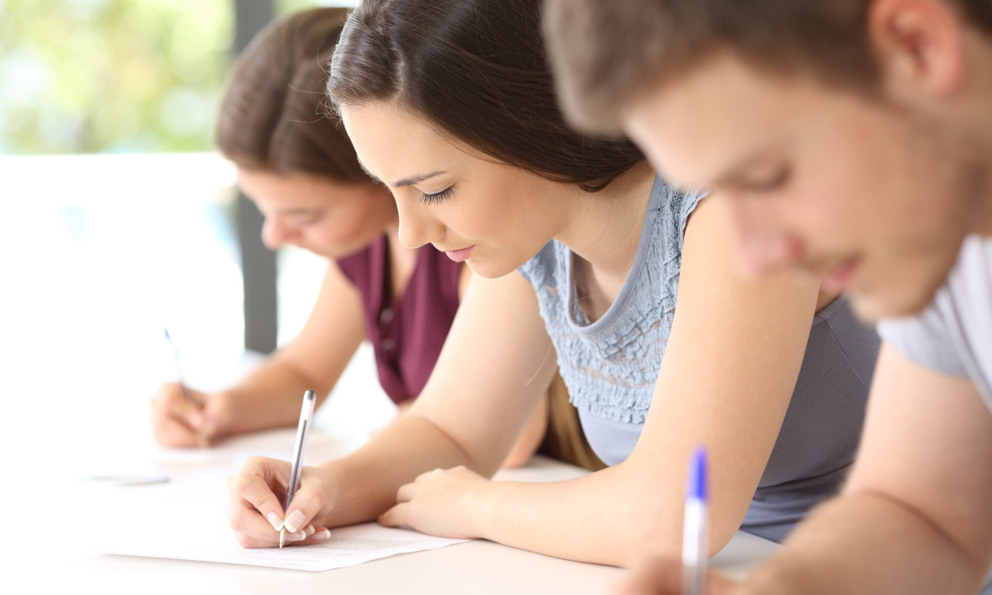close up of three students taking a test